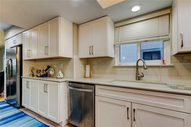 9484 Tara Cay Ct Unit 8, Seminole, FL 33776 - kitchen with appliances with stainless steel finishes, white cabinetry, and light countertops