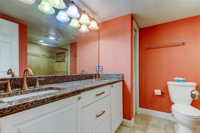 9484 Tara Cay Ct Unit 8, Seminole, FL 33776 - bathroom with a shower stall, toilet, tile patterned flooring, baseboards, and double vanity