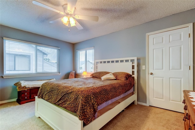 9484 Tara Cay Ct Unit 8, Seminole, FL 33776 - bedroom with light carpet, baseboards, a ceiling fan, and a textured ceiling