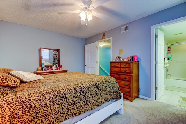 9484 Tara Cay Ct Unit 8, Seminole, FL 33776 - bedroom with light carpet, a textured ceiling, ceiling fan, and ensuite bathroom