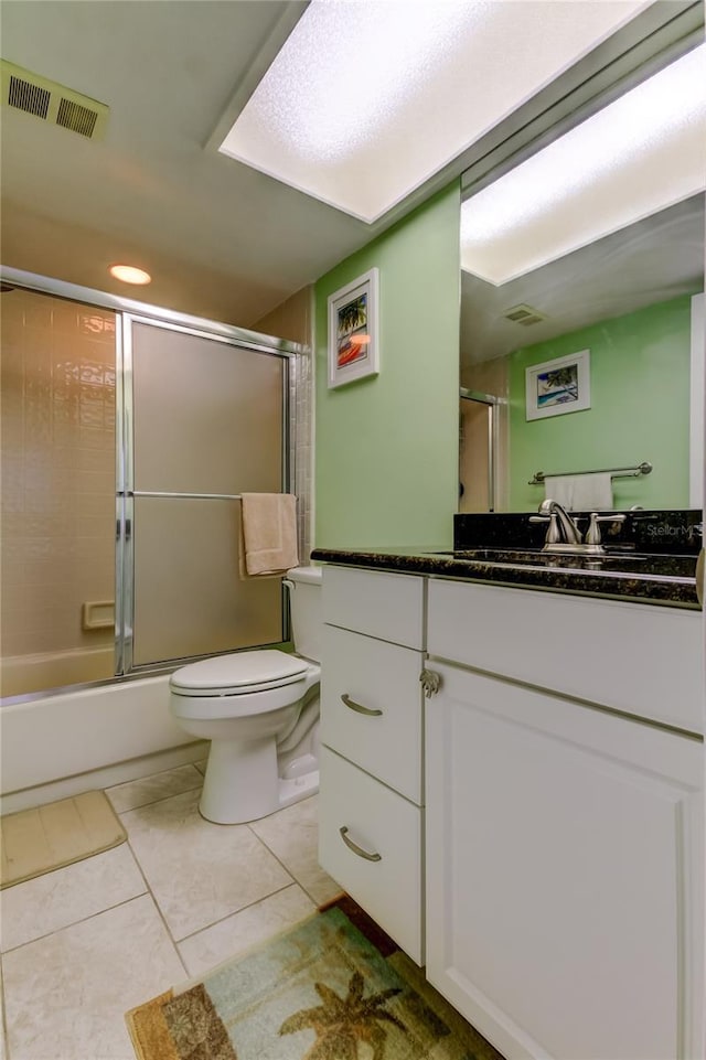 9484 Tara Cay Ct Unit 8, Seminole, FL 33776 - full bathroom with toilet, tile patterned flooring, vanity, and bath / shower combo with glass door
