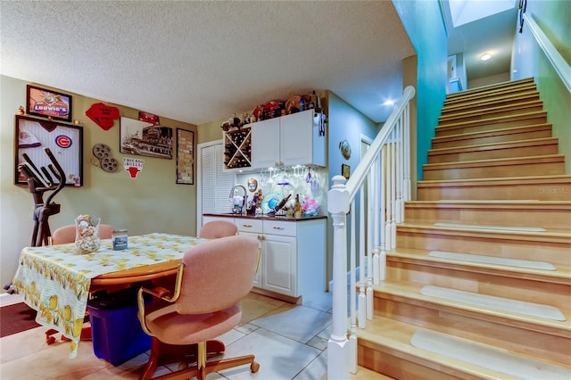 9484 Tara Cay Ct Unit 8, Seminole, FL 33776 - dining room featuring stairway, a textured ceiling, light tile patterned floors, and a skylight