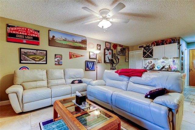 9484 Tara Cay Ct Unit 8, Seminole, FL 33776 - living room featuring ceiling fan, a textured ceiling, and light tile patterned floors