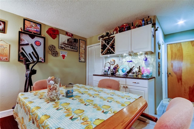 9484 Tara Cay Ct Unit 8, Seminole, FL 33776 - dining space with a textured ceiling, tile patterned flooring, and baseboards
