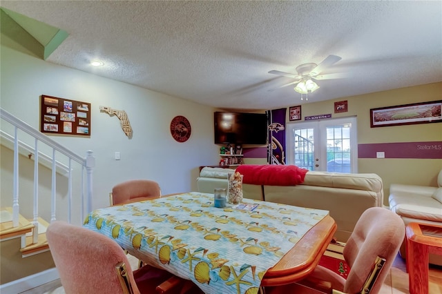9484 Tara Cay Ct Unit 8, Seminole, FL 33776 - dining space featuring ceiling fan, a textured ceiling, french doors, and stairs