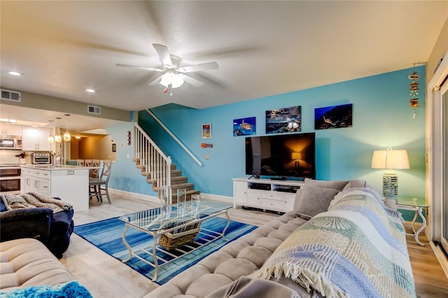 9484 Tara Cay Ct Unit 8, Seminole, FL 33776 - living room with stairway, a ceiling fan, light wood-style flooring, baseboards, and recessed lighting