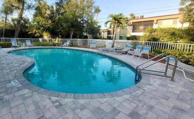 9484 Tara Cay Ct Unit 8, Seminole, FL 33776 - community pool with fence and a patio area