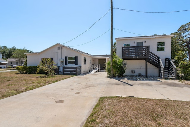 2911 16th Ave S Unit A, Saint Petersburg, FL 33712 - view of front of home featuring stucco siding, a front yard, and stairway