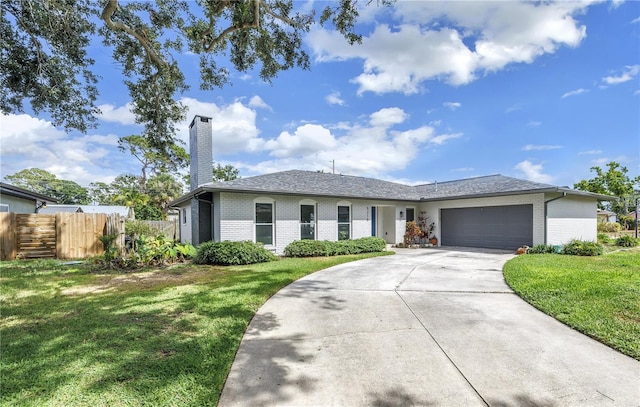 5215 Denver St NE, Saint Petersburg, FL 33703 - ranch-style house with brick siding, an attached garage, a chimney, and concrete driveway
