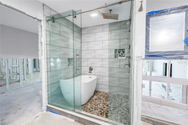 5215 Denver St NE, Saint Petersburg, FL 33703 - full bathroom featuring a shower stall, a freestanding bath, and concrete floors