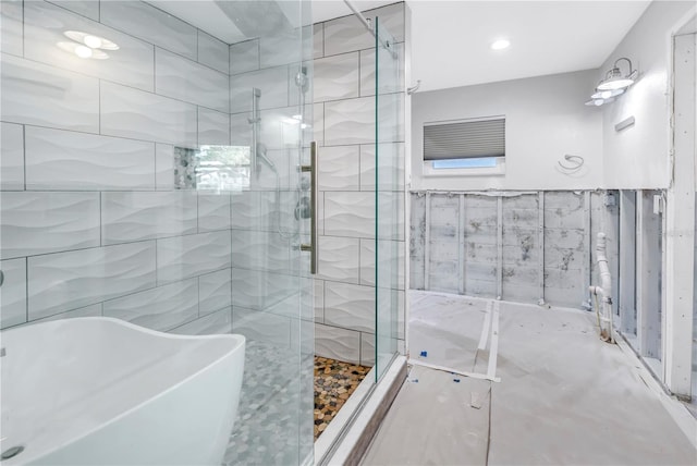 5215 Denver St NE, Saint Petersburg, FL 33703 - bathroom with a shower stall, tile walls, and a freestanding bath