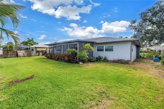 5215 Denver St NE, Saint Petersburg, FL 33703 - rear view of house with a sunroom, stucco siding, and a chimney