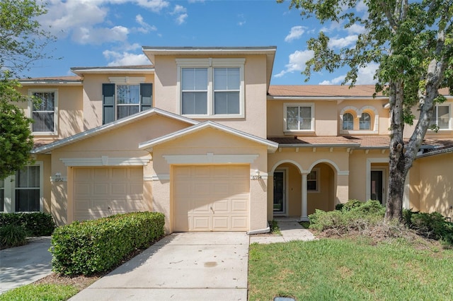 6954 Hawthorne Trace Ln, Riverview, FL 33578 - townhome / multi-family property with stucco siding, driveway, and an attached garage