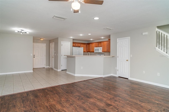 6954 Hawthorne Trace Ln, Riverview, FL 33578 - unfurnished living room with light wood-style floors, recessed lighting, baseboards, ceiling fan, and stairs