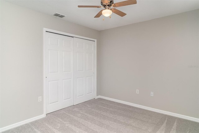 6954 Hawthorne Trace Ln, Riverview, FL 33578 - unfurnished bedroom featuring light colored carpet, a closet, baseboards, and a ceiling fan