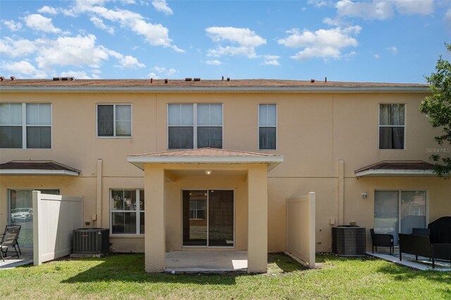 6954 Hawthorne Trace Ln, Riverview, FL 33578 - rear view of house featuring central air condition unit, a patio, stucco siding, and a yard