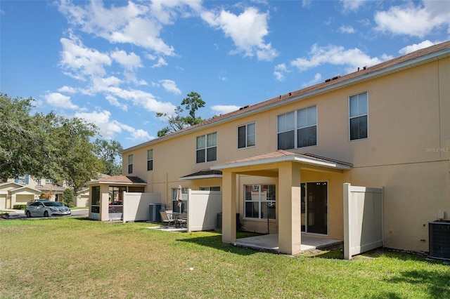6954 Hawthorne Trace Ln, Riverview, FL 33578 - rear view of house featuring stucco siding, central AC unit, and a patio area