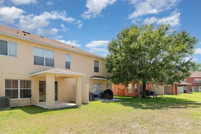 6954 Hawthorne Trace Ln, Riverview, FL 33578 - rear view of house featuring a patio area, cooling unit, stucco siding, and a lawn
