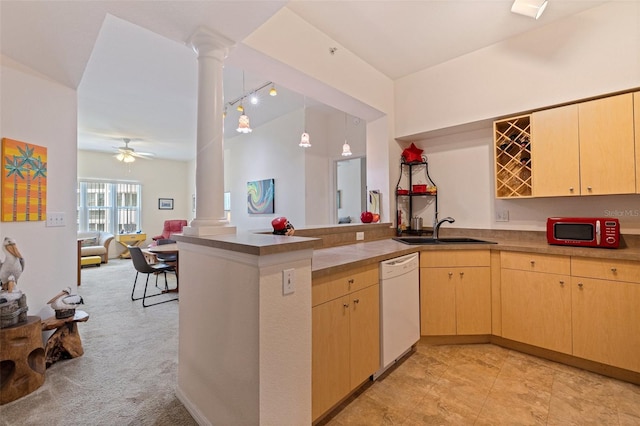 200 4th Ave S Unit 220, Saint Petersburg, FL 33701 - kitchen featuring decorative columns, white dishwasher, a peninsula, and light brown cabinetry