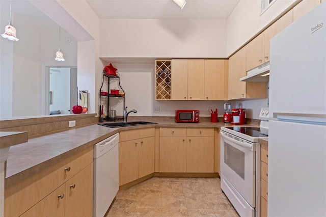 200 4th Ave S Unit 220, Saint Petersburg, FL 33701 - kitchen with white appliances, under cabinet range hood, light brown cabinetry, and pendant lighting