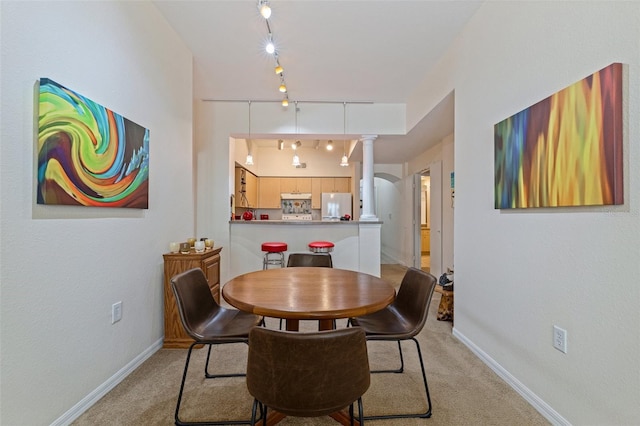 200 4th Ave S Unit 220, Saint Petersburg, FL 33701 - dining space featuring rail lighting, decorative columns, and light colored carpet