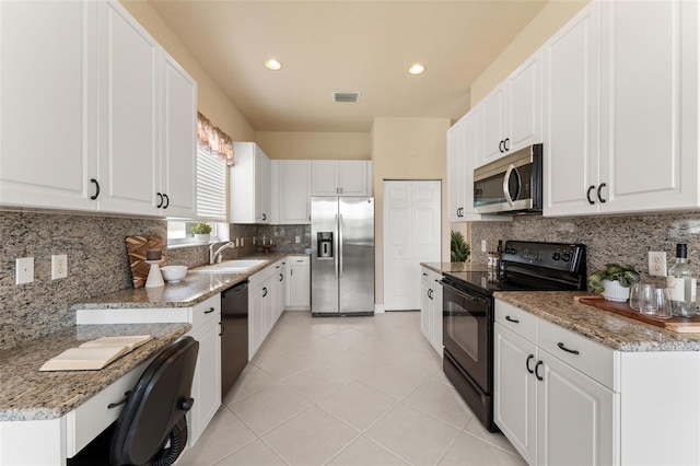 5009 Sandy Brook Cir, Wimauma, FL 33598 - kitchen featuring black appliances, light tile patterned floors, white cabinetry, backsplash, and recessed lighting