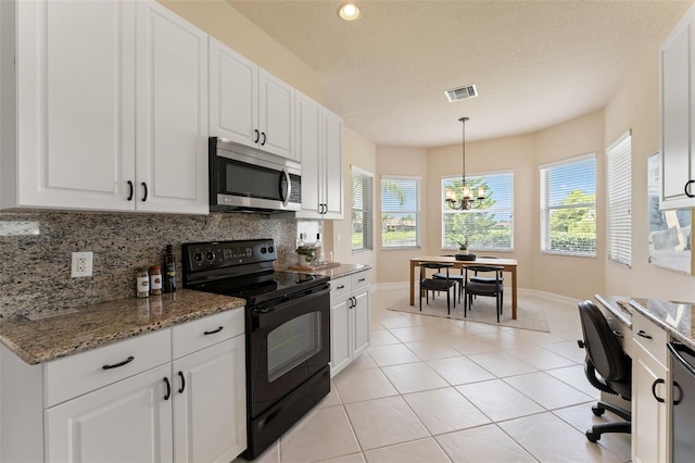 5009 Sandy Brook Cir, Wimauma, FL 33598 - kitchen featuring stainless steel microwave, black / electric stove, healthy amount of natural light, decorative backsplash, and recessed lighting