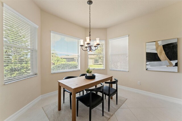 5009 Sandy Brook Cir, Wimauma, FL 33598 - dining space featuring a chandelier and light tile patterned flooring
