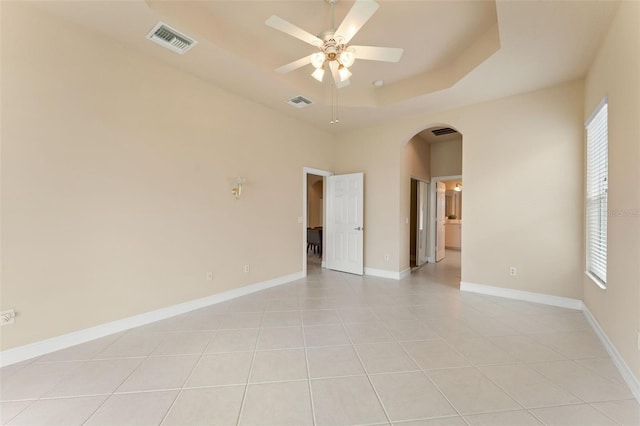 5009 Sandy Brook Cir, Wimauma, FL 33598 - empty room with arched walkways, plenty of natural light, a ceiling fan, and light tile patterned floors