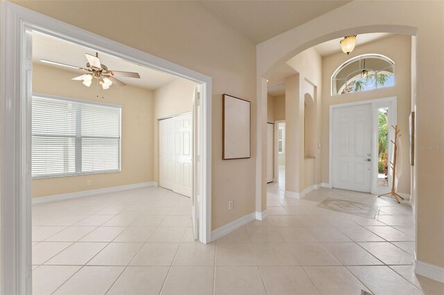 5009 Sandy Brook Cir, Wimauma, FL 33598 - foyer entrance with light tile patterned floors, ceiling fan, arched walkways, and a high ceiling