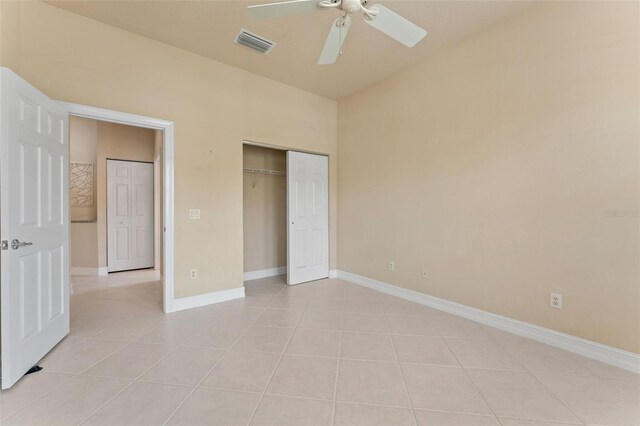 5009 Sandy Brook Cir, Wimauma, FL 33598 - unfurnished bedroom featuring light tile patterned flooring, a closet, and ceiling fan