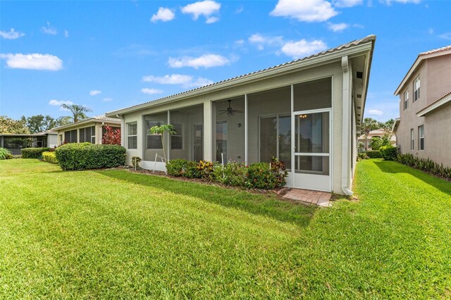 5009 Sandy Brook Cir, Wimauma, FL 33598 - rear view of house with a sunroom, a lawn, and ceiling fan