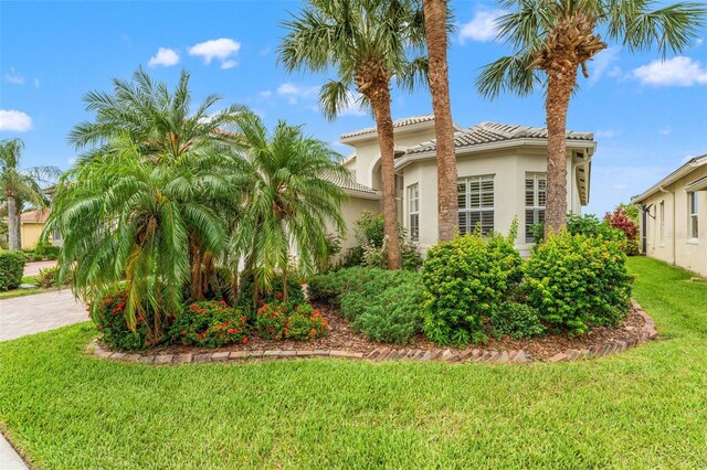 5009 Sandy Brook Cir, Wimauma, FL 33598 - view of front of house featuring stucco siding, a front lawn, and a tiled roof
