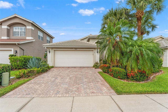 5009 Sandy Brook Cir, Wimauma, FL 33598 - view of front of house with decorative driveway, stucco siding, a tile roof, and an attached garage