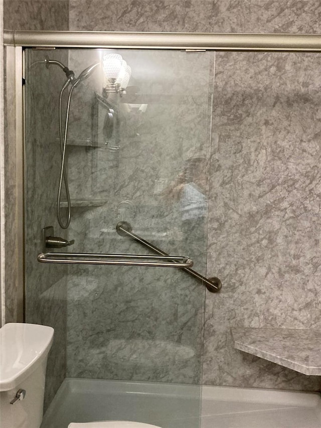 full bath with a shower stall and toilet