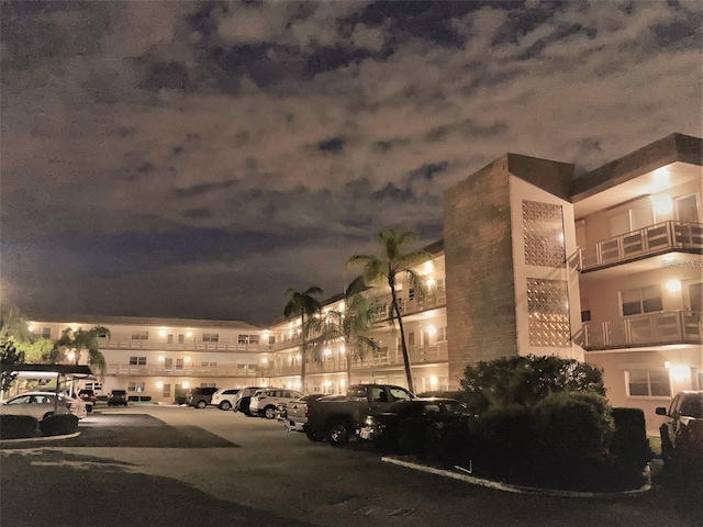property at twilight featuring uncovered parking