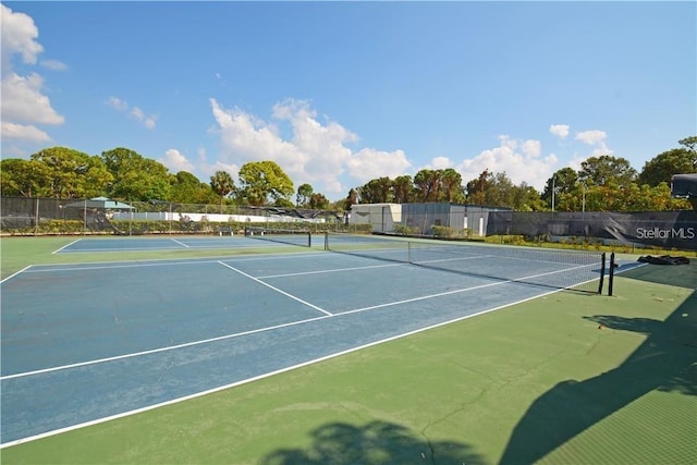 view of tennis court featuring fence