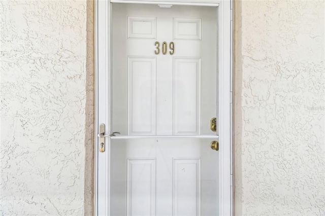 200 1st Ave Unit 309, St Pete Beach, FL 33706 - doorway to property with stucco siding