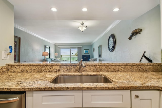 200 1st Ave Unit 309, St Pete Beach, FL 33706 - kitchen featuring a sink, white cabinetry, ornamental molding, light stone countertops, and recessed lighting