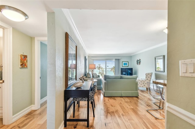 200 1st Ave Unit 309, St Pete Beach, FL 33706 - living room featuring crown molding, light wood finished floors, and baseboards