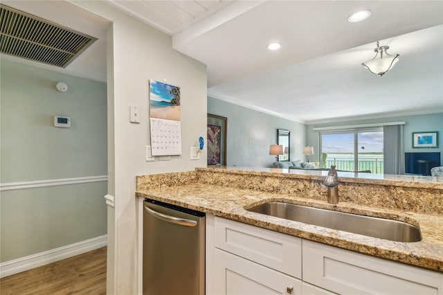 200 1st Ave Unit 309, St Pete Beach, FL 33706 - kitchen with a sink, dishwasher, light stone counters, white cabinets, and ornamental molding