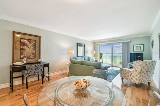 200 1st Ave Unit 309, St Pete Beach, FL 33706 - dining room featuring wood finished floors, ornamental molding, and baseboards