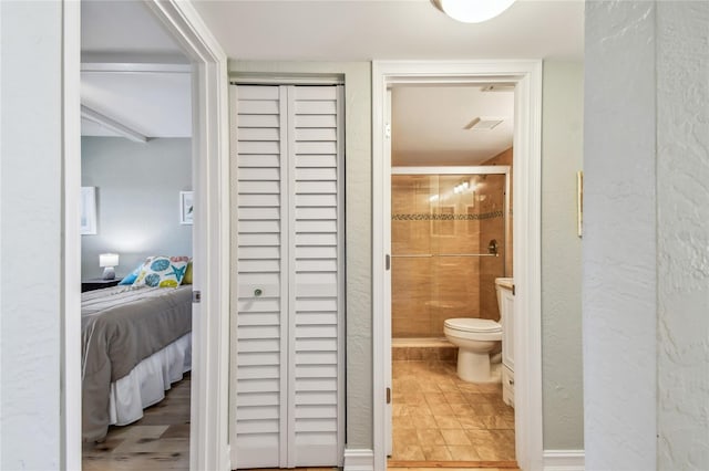 200 1st Ave Unit 309, St Pete Beach, FL 33706 - ensuite bathroom with a shower stall, toilet, and a textured wall