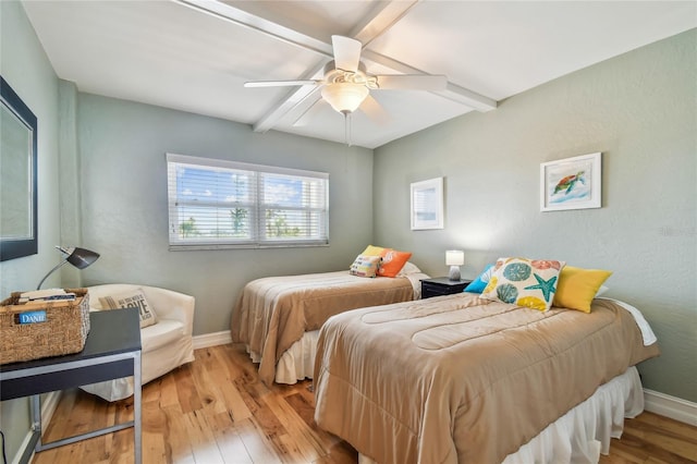 200 1st Ave Unit 309, St Pete Beach, FL 33706 - bedroom featuring hardwood / wood-style floors, beamed ceiling, baseboards, and ceiling fan