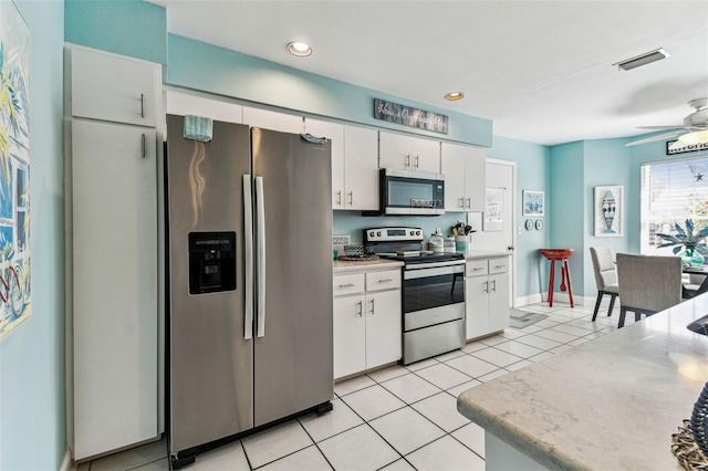 3520 51st Ave W, Bradenton, FL 34210 - kitchen featuring stainless steel appliances, light countertops, white cabinetry, light tile patterned floors, and ceiling fan