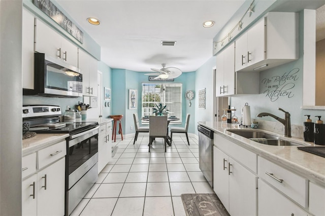 3520 51st Ave W, Bradenton, FL 34210 - kitchen featuring appliances with stainless steel finishes, a sink, light countertops, white cabinetry, and recessed lighting