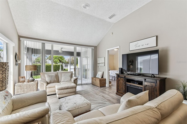 3520 51st Ave W, Bradenton, FL 34210 - living area with a textured ceiling, wood finished floors, and high vaulted ceiling