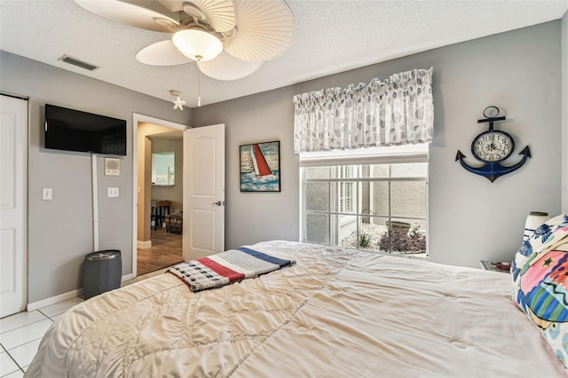 3520 51st Ave W, Bradenton, FL 34210 - bedroom featuring tile patterned flooring, baseboards, a ceiling fan, and a textured ceiling
