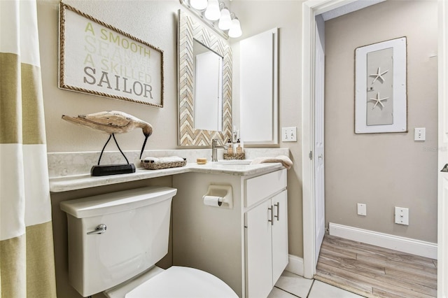 3520 51st Ave W, Bradenton, FL 34210 - bathroom featuring toilet, vanity, baseboards, and wood finished floors