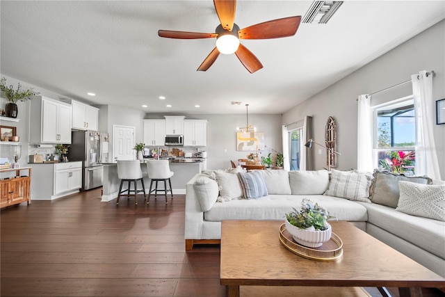living room with dark wood-style flooring, recessed lighting, and ceiling fan